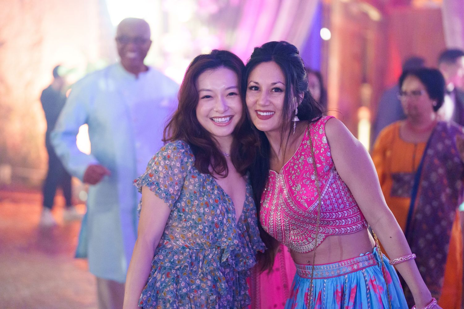 Guests in colorful attire celebrating at a festive wedding reception.