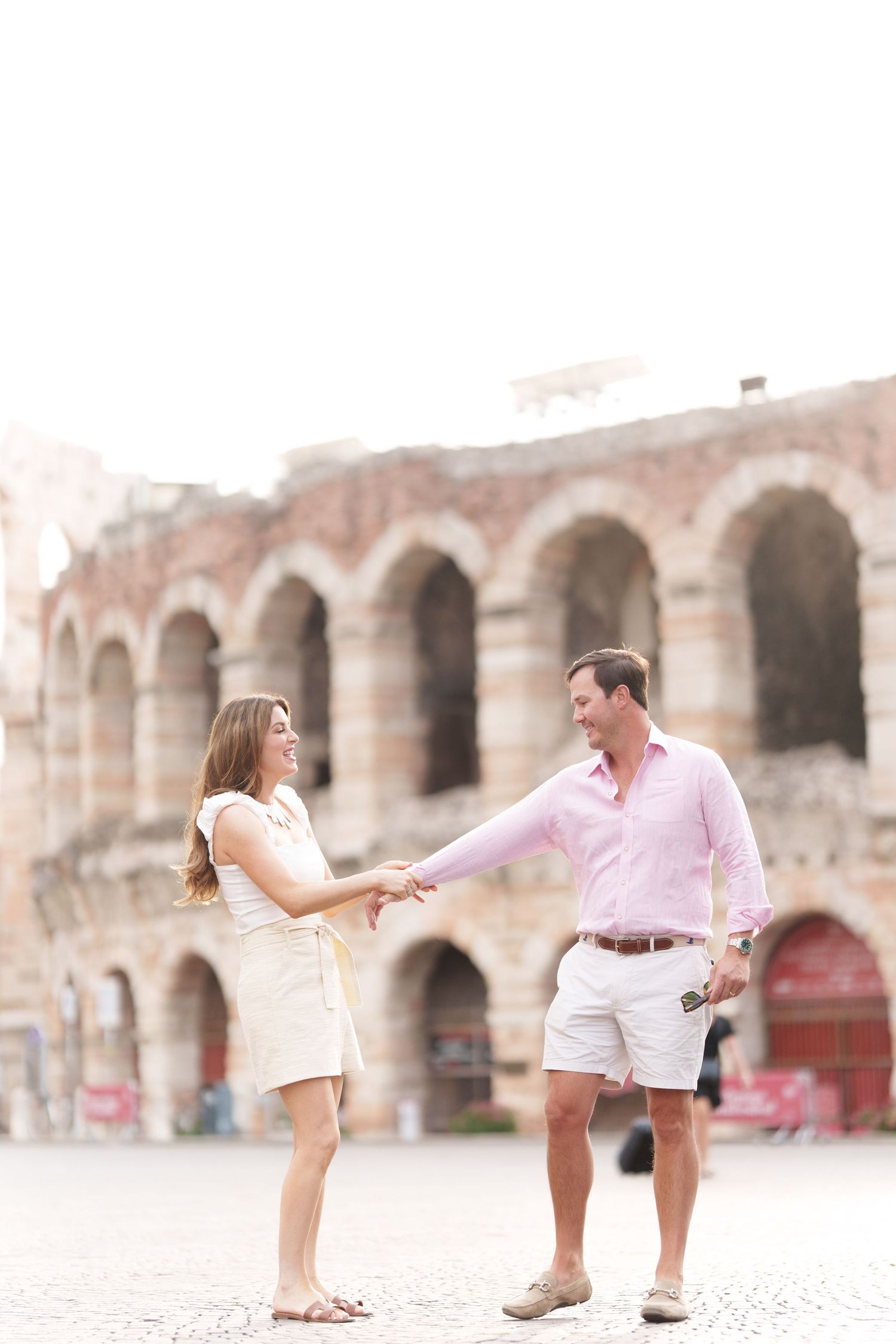 Verona family photographer family walking in front of Verona Arena Italy