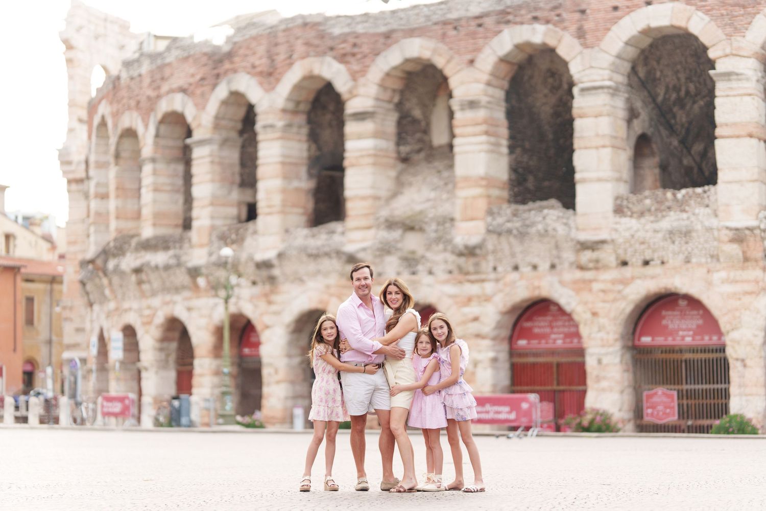 Verona family photographer family walking in front of Verona Arena Italy