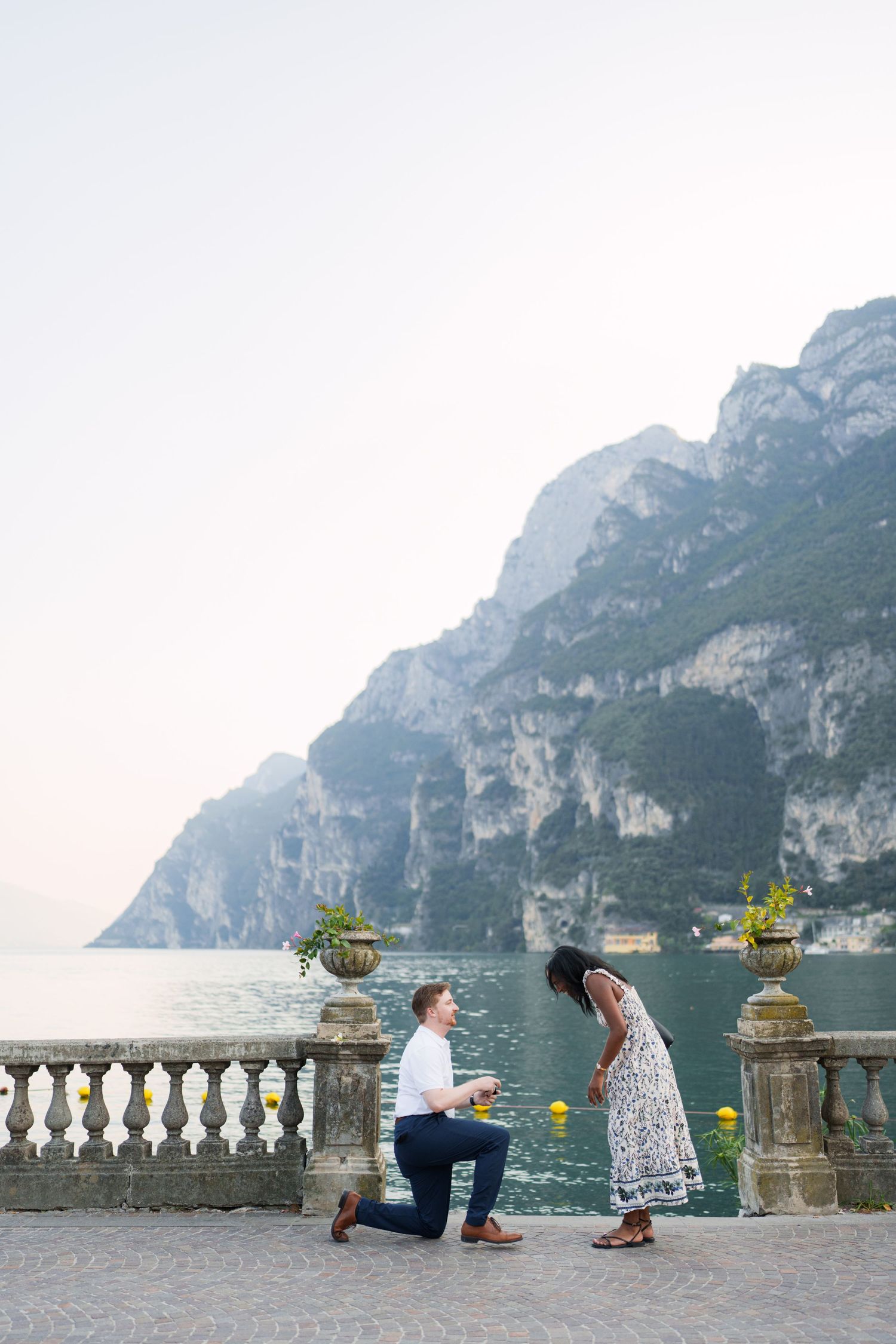 Surprise marriage proposal on one knee overlooking Lake Garda in Riva del Garda, Italy