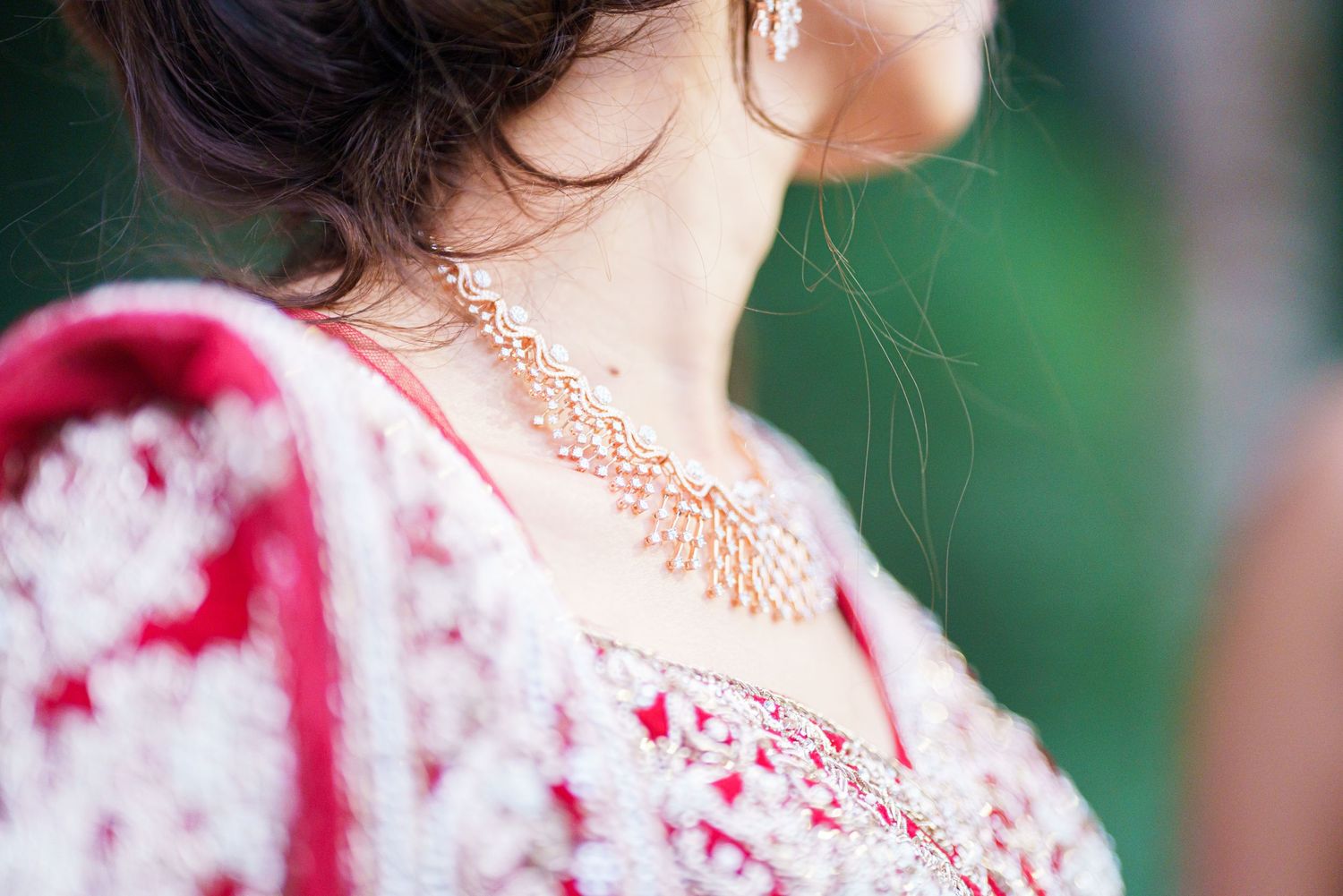 Close-up detail of intricate gold jewelry and red attire.