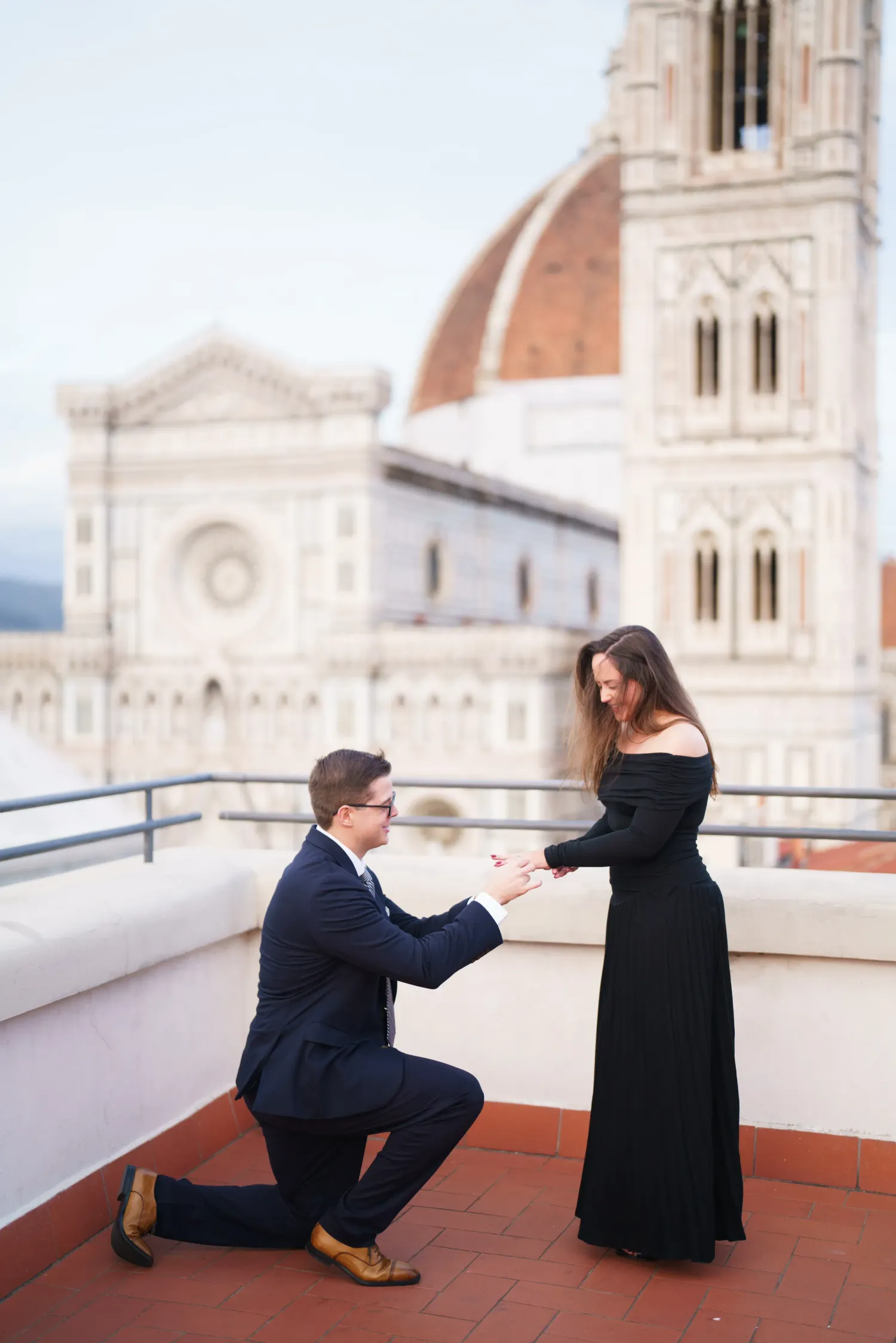 A sequence of proposal photos showing a couple on a rooftop terrace with a cathedral backdrop in Florence, Italy.