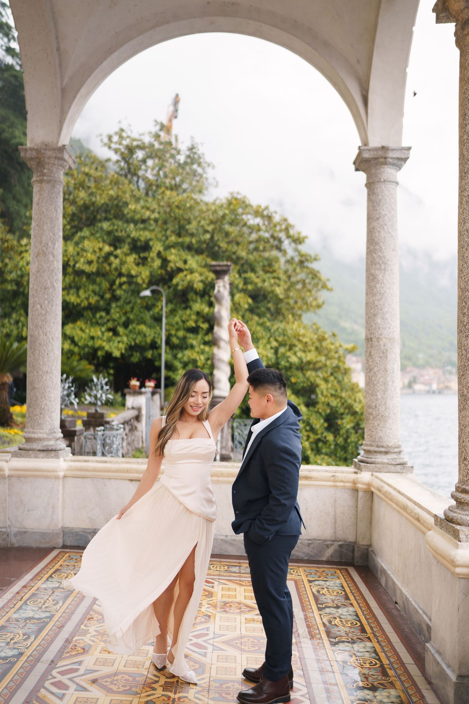 Lake Como proposal photographer capturing surprise engagement at Villa Monastero in Varenna