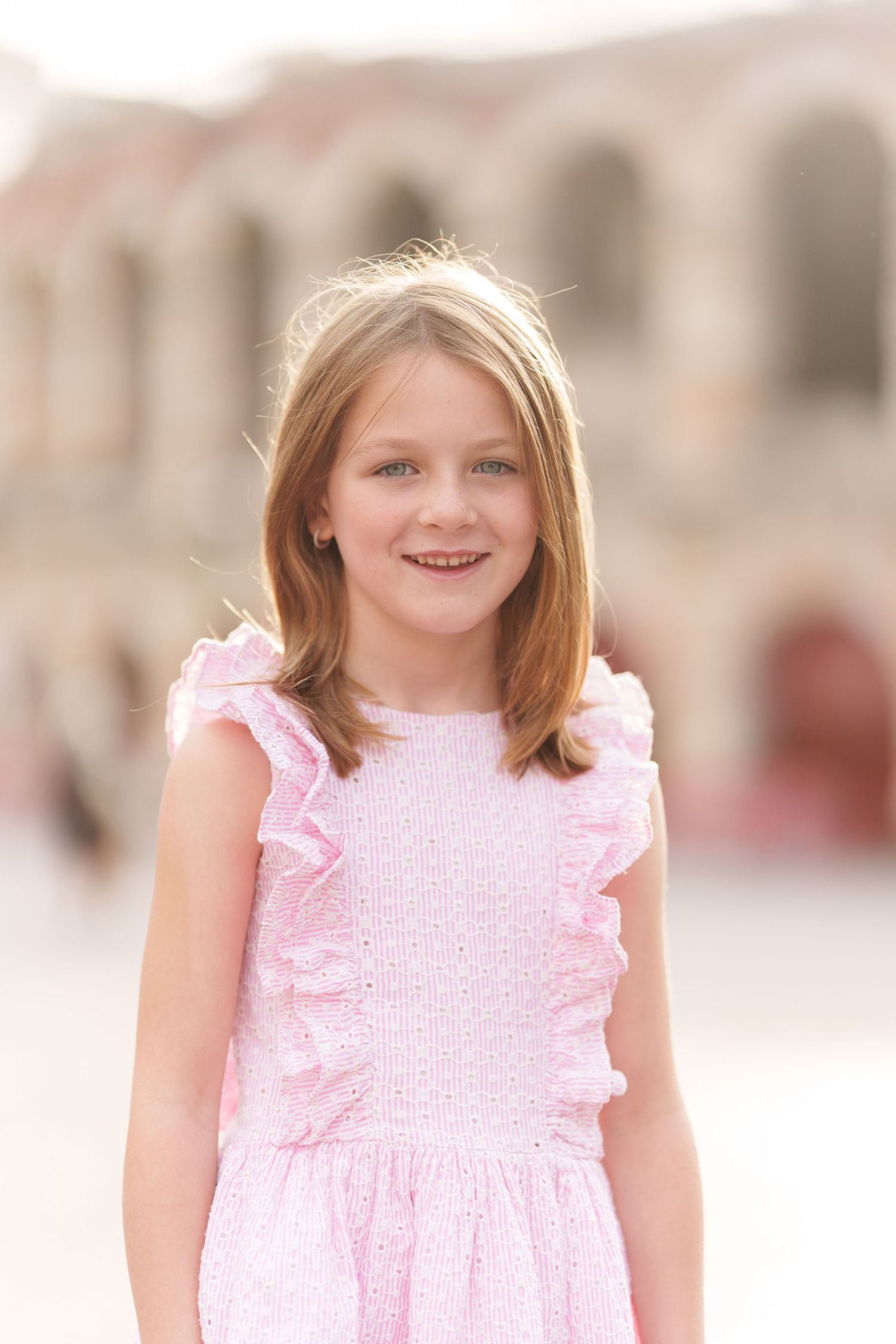 Verona family photographer family walking in front of Verona Arena Italy