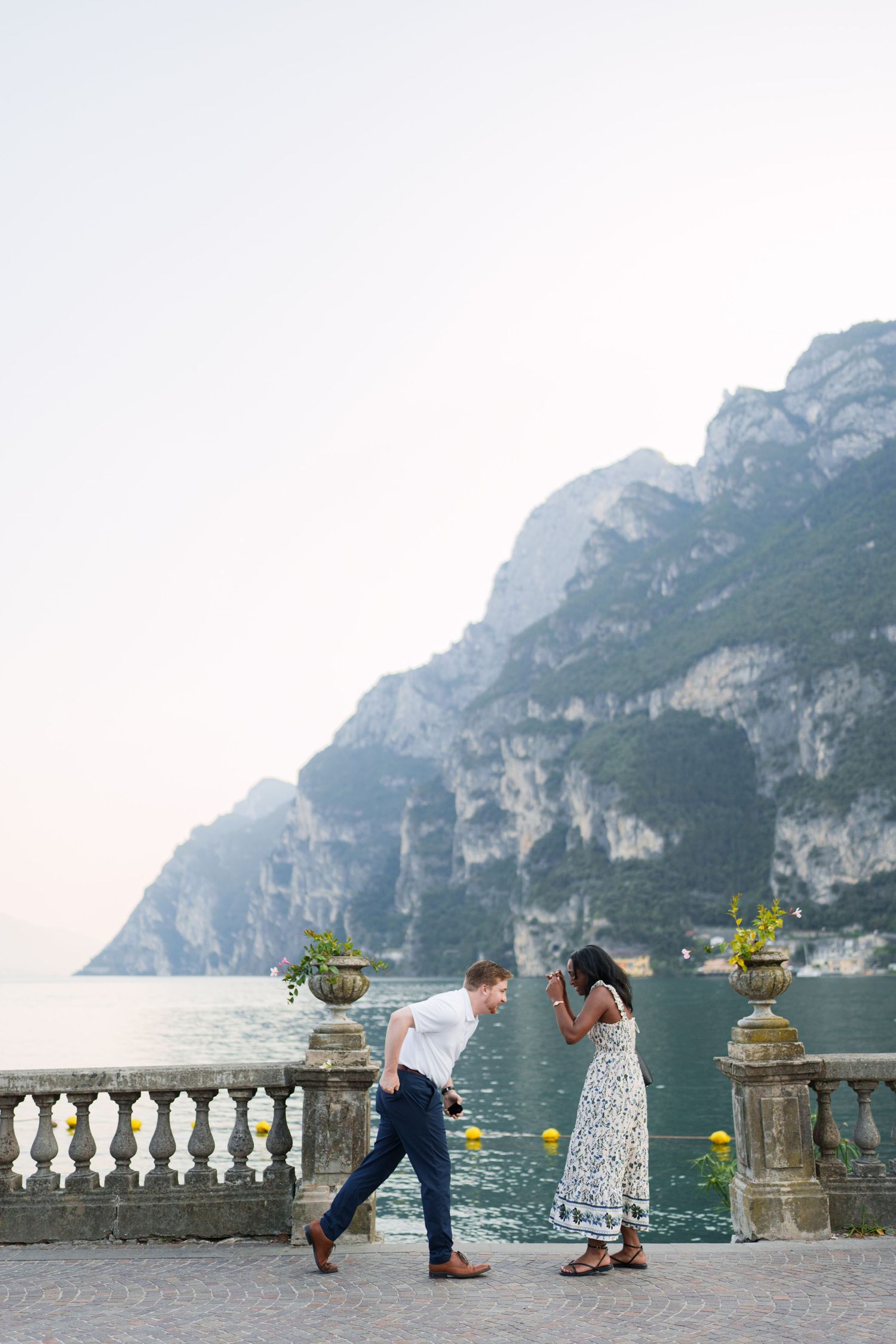 Surprise marriage proposal on one knee overlooking Lake Garda in Riva del Garda, Italy