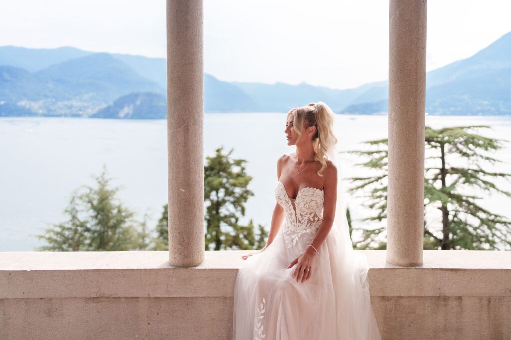 Stone colonnade terrace with mountain and lake views providing an elegant wedding venue backdrop.