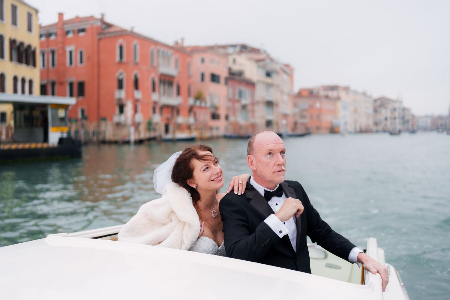 A romantic couple shares an intimate moment while riding in a gondola along the canals of Venice, Italy.
