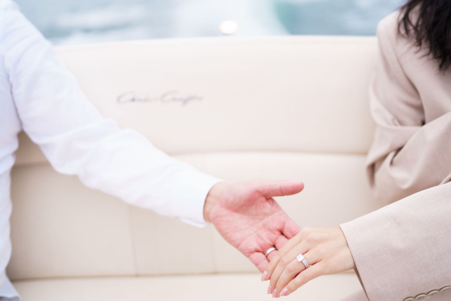 Close-up of hands performing reiki or energy healing therapy on a white surface.
