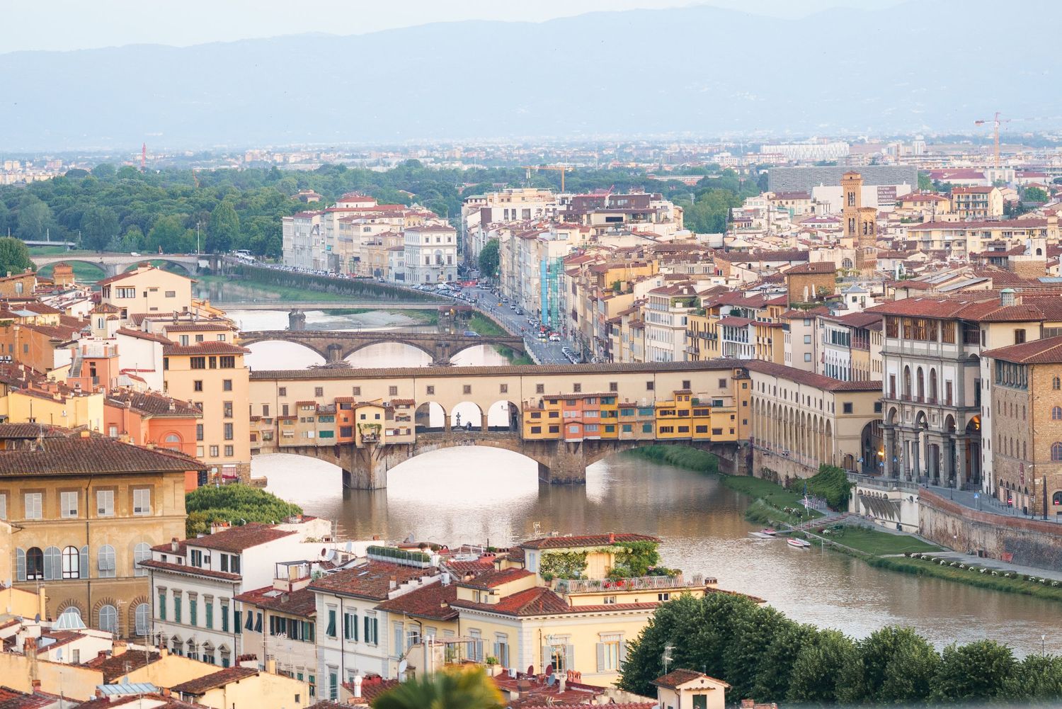 Panoramic cityscape of Florence showing Ponte Vecchio bridge and Arno River.