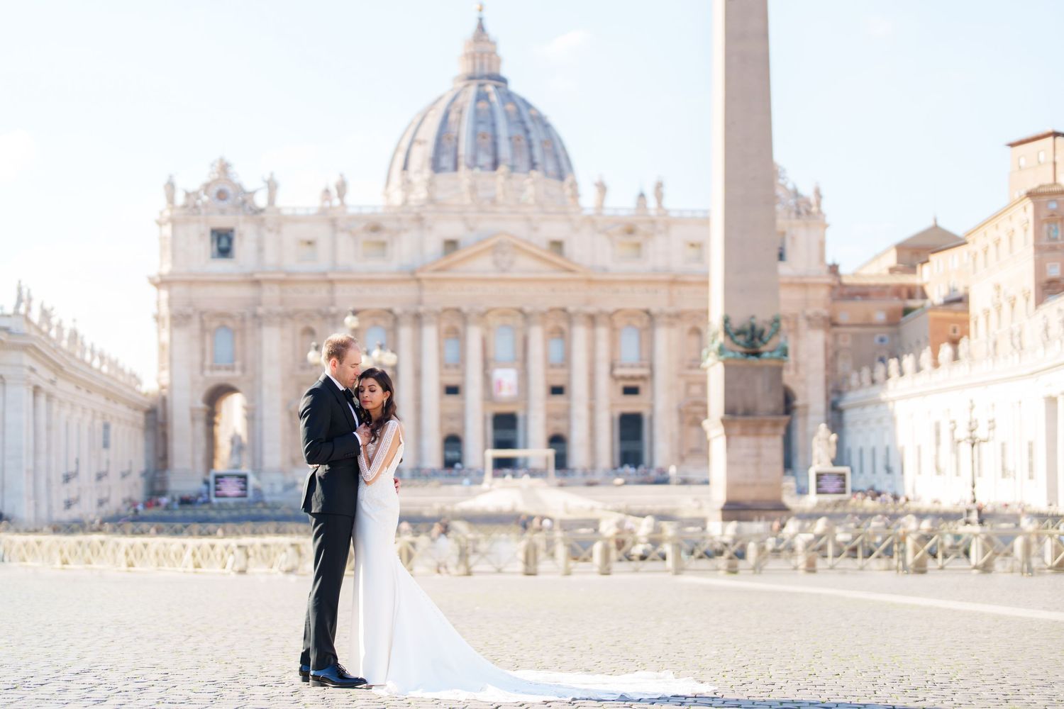 A romantic photoshoot in front of St. Peter's Basilica at Vatican City with the iconic dome in the background.