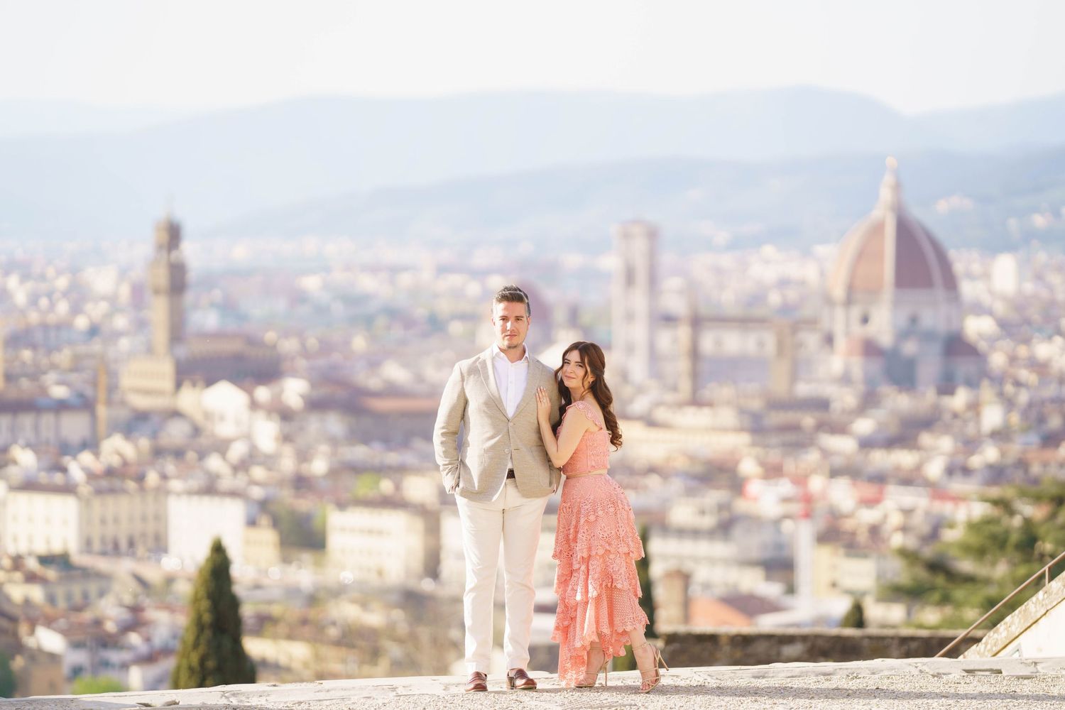 A panoramic view of Florence, Italy with the iconic Duomo cathedral dome rising above the historic cityscape.