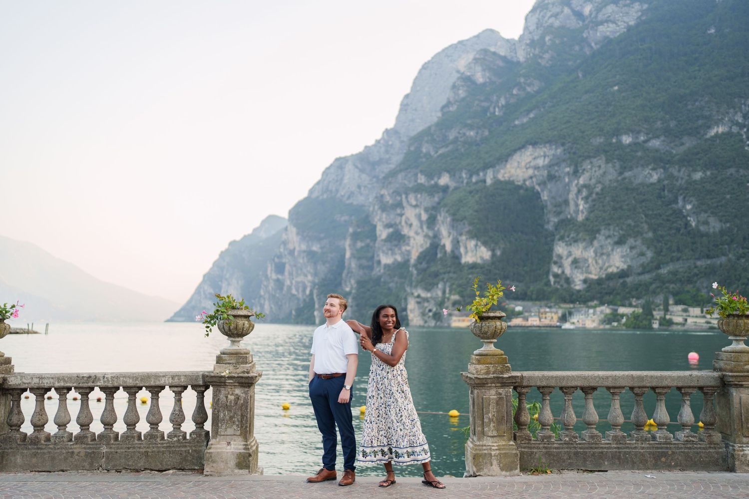 Engaged couple embracing beside Lake Garda during their Riva del Garda proposal session