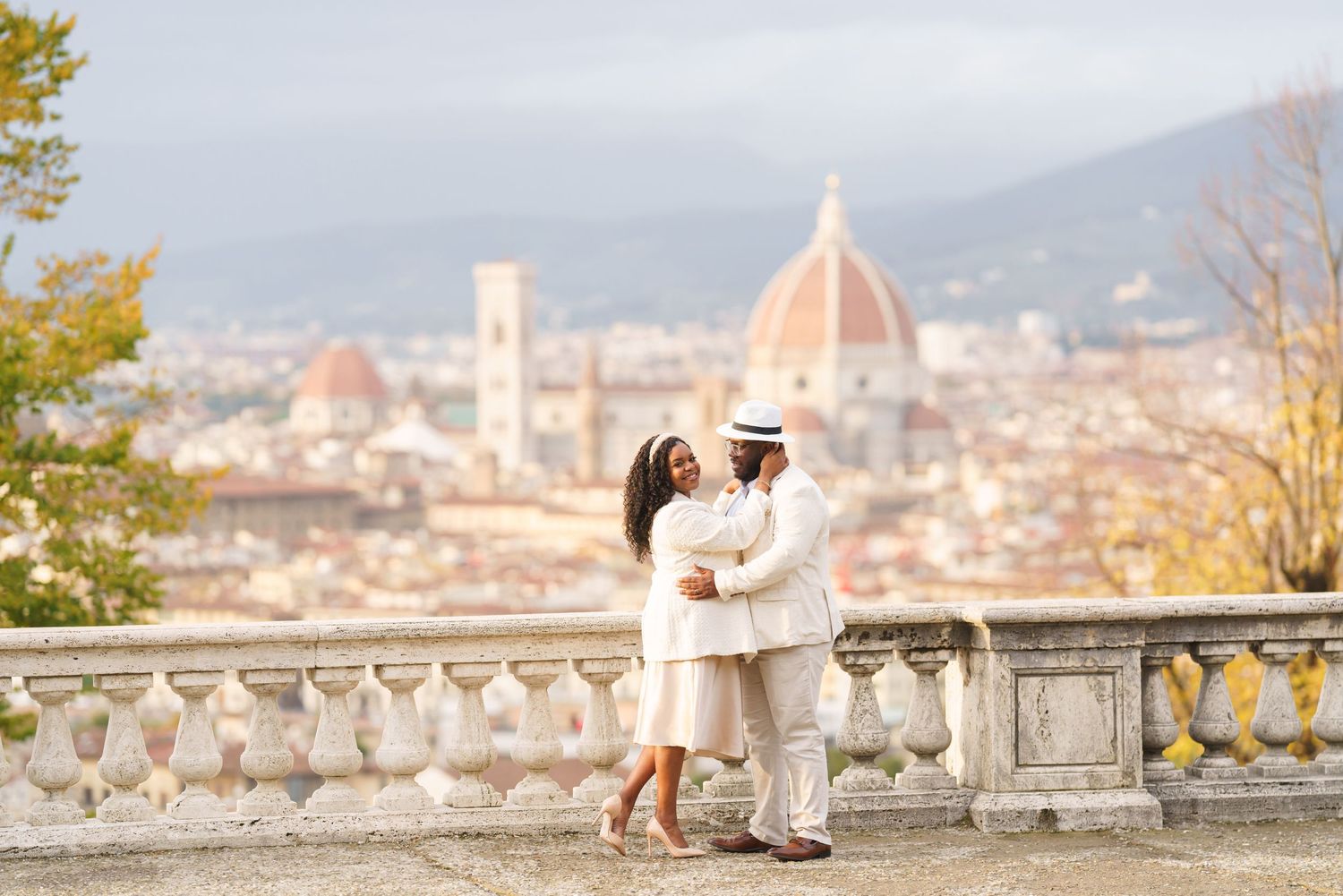 Couple dancing romantically on a terrace overlooking Florence skyline with the iconic Duomo cathedral in the background.