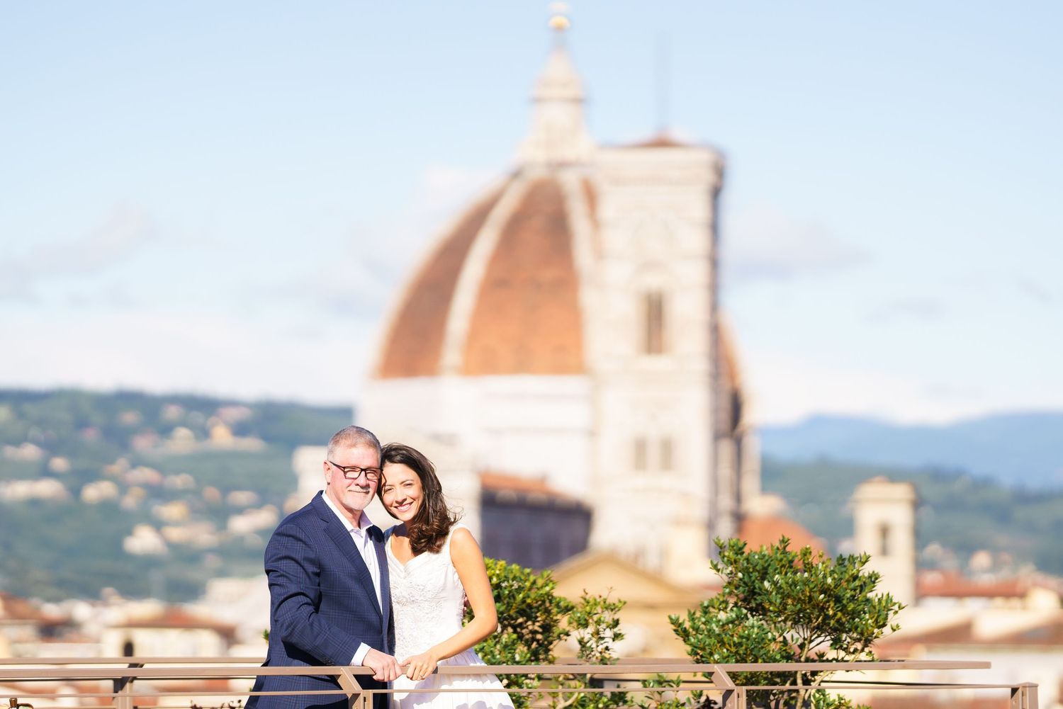 Romantic photoshoot on a Florence rooftop terrace with the Duomo cathedral visible in the distance.