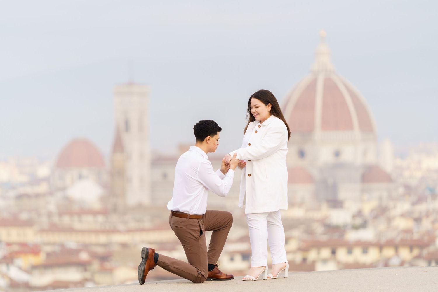 Romantic proposal scene overlooking Florence Cathedral and cityscape.