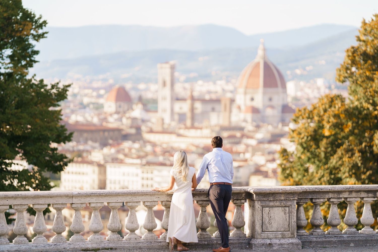 A panoramic view of Florence's iconic Duomo cathedral and cityscape from Piazzale Michelangelo at sunset.