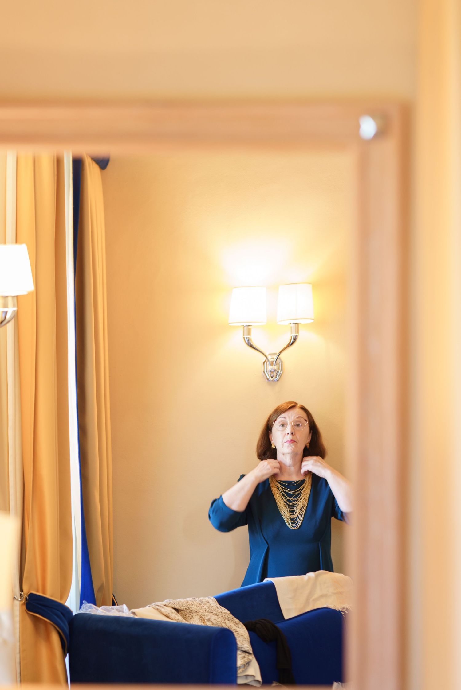 Interior room with warm lighting and wall sconces creating an elegant ambiance.