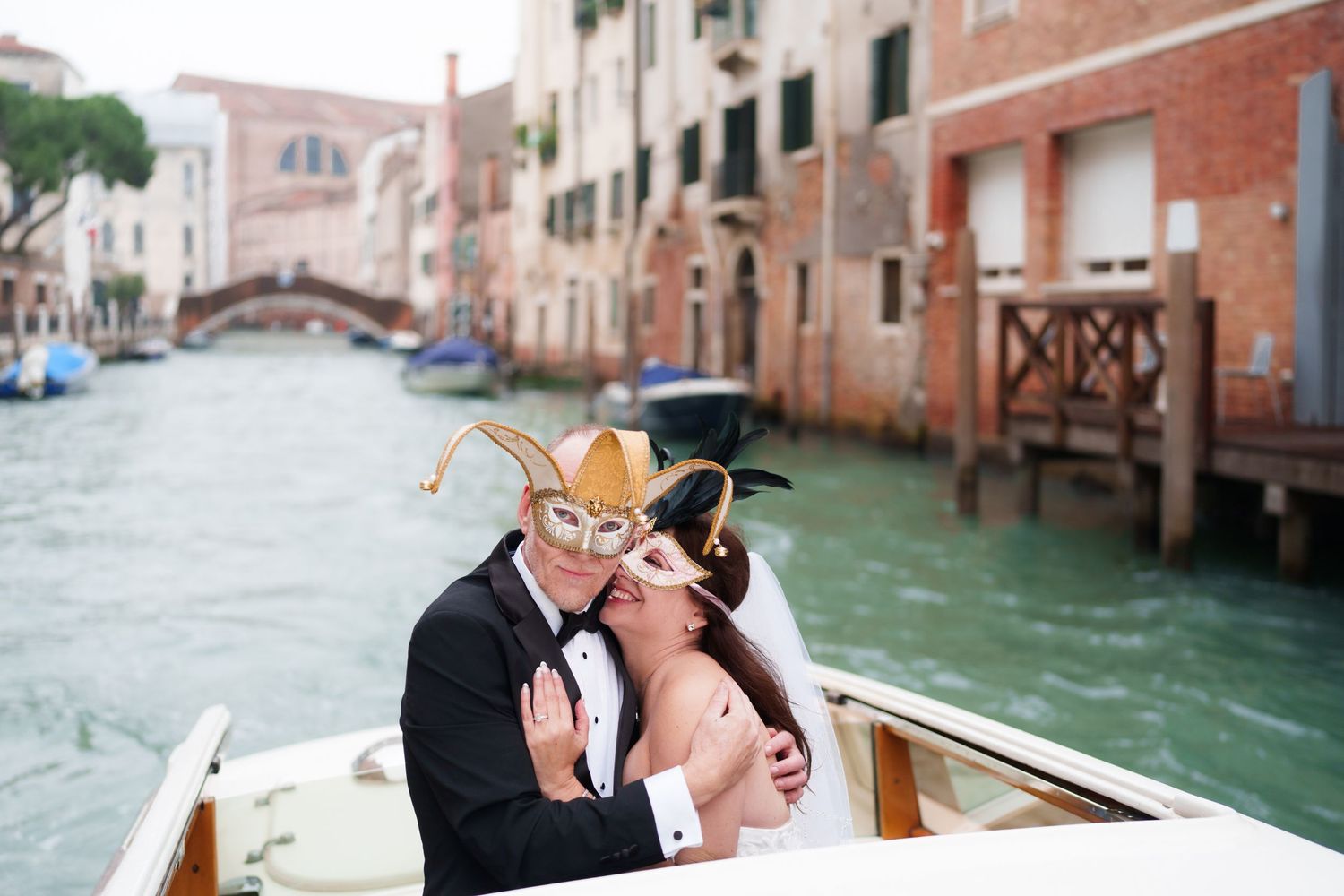 A romantic couple shares intimate moments while riding in a gondola through the scenic canals of Venice, Italy.