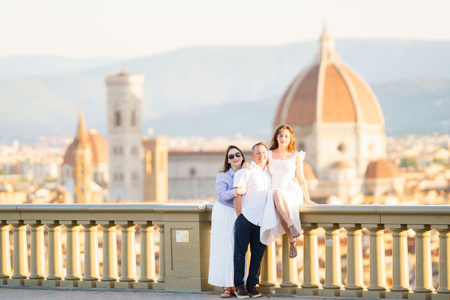 A couple poses for romantic photos with the iconic Florence Cathedral and cityscape in the background.