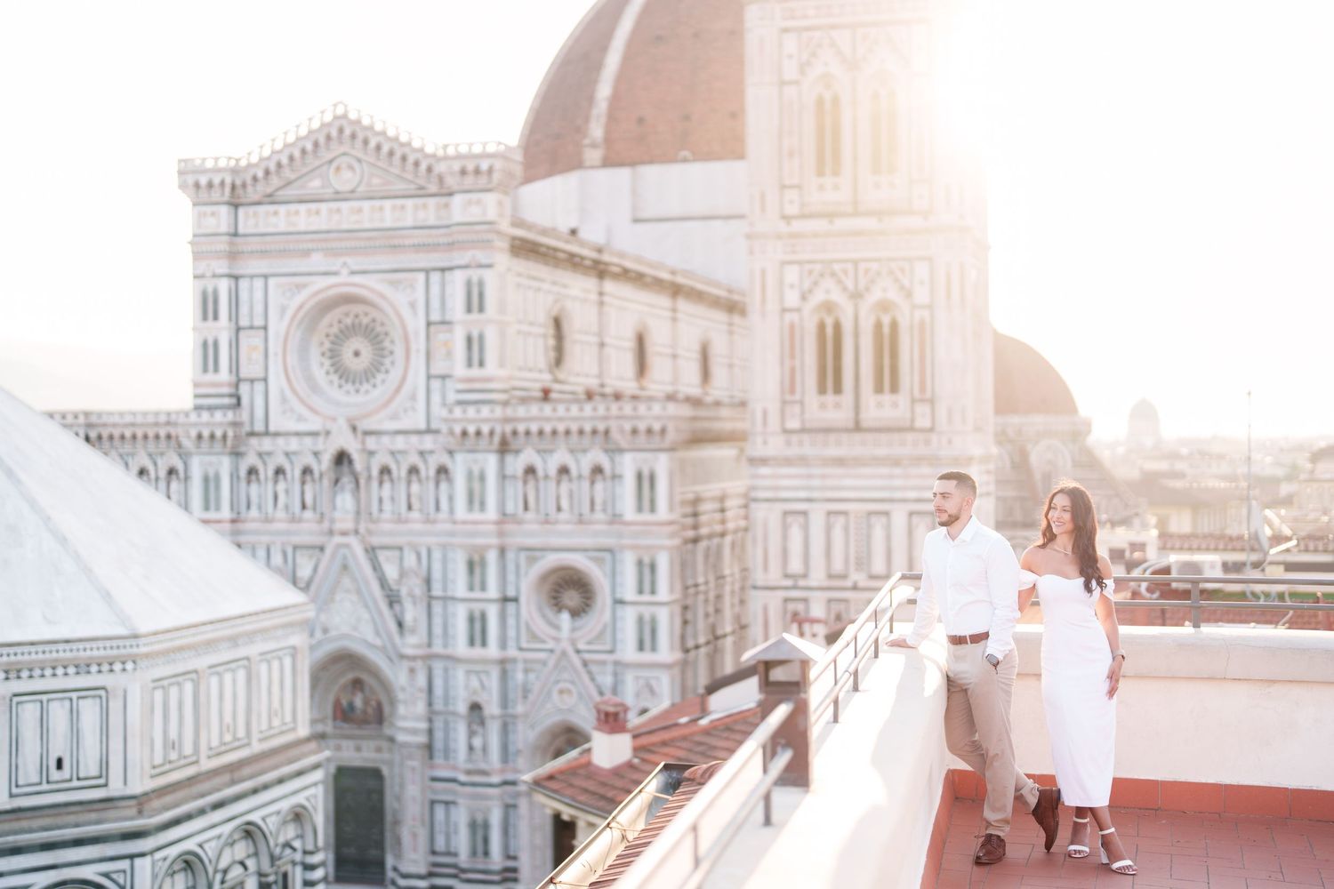 Panoramic view of Florence Cathedral and historic buildings in Italy during golden sunset hour.