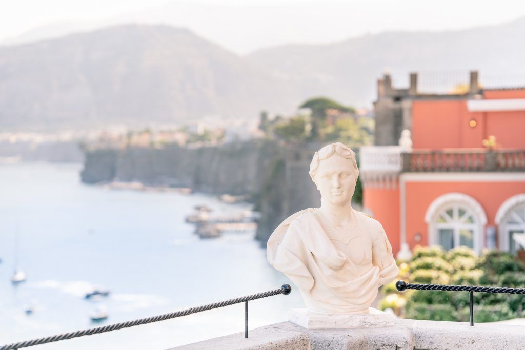 Stunning coastal view of Sorrento's cliffs and bay from a luxury hotel terrace.