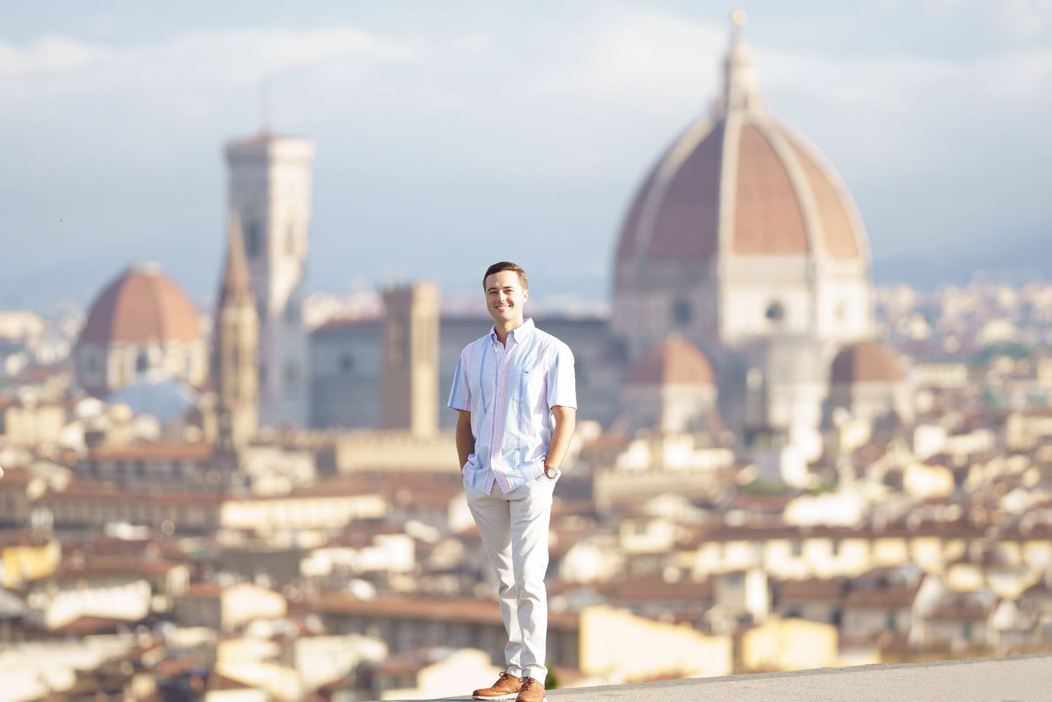 A panoramic view of Florence, Italy, showcasing the iconic Duomo cathedral and historic skyline at sunset.