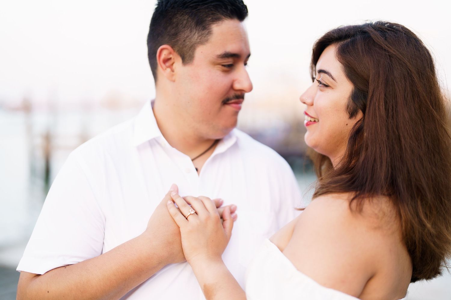 A romantic couple shares tender moments together in a series of engagement photos outdoors.