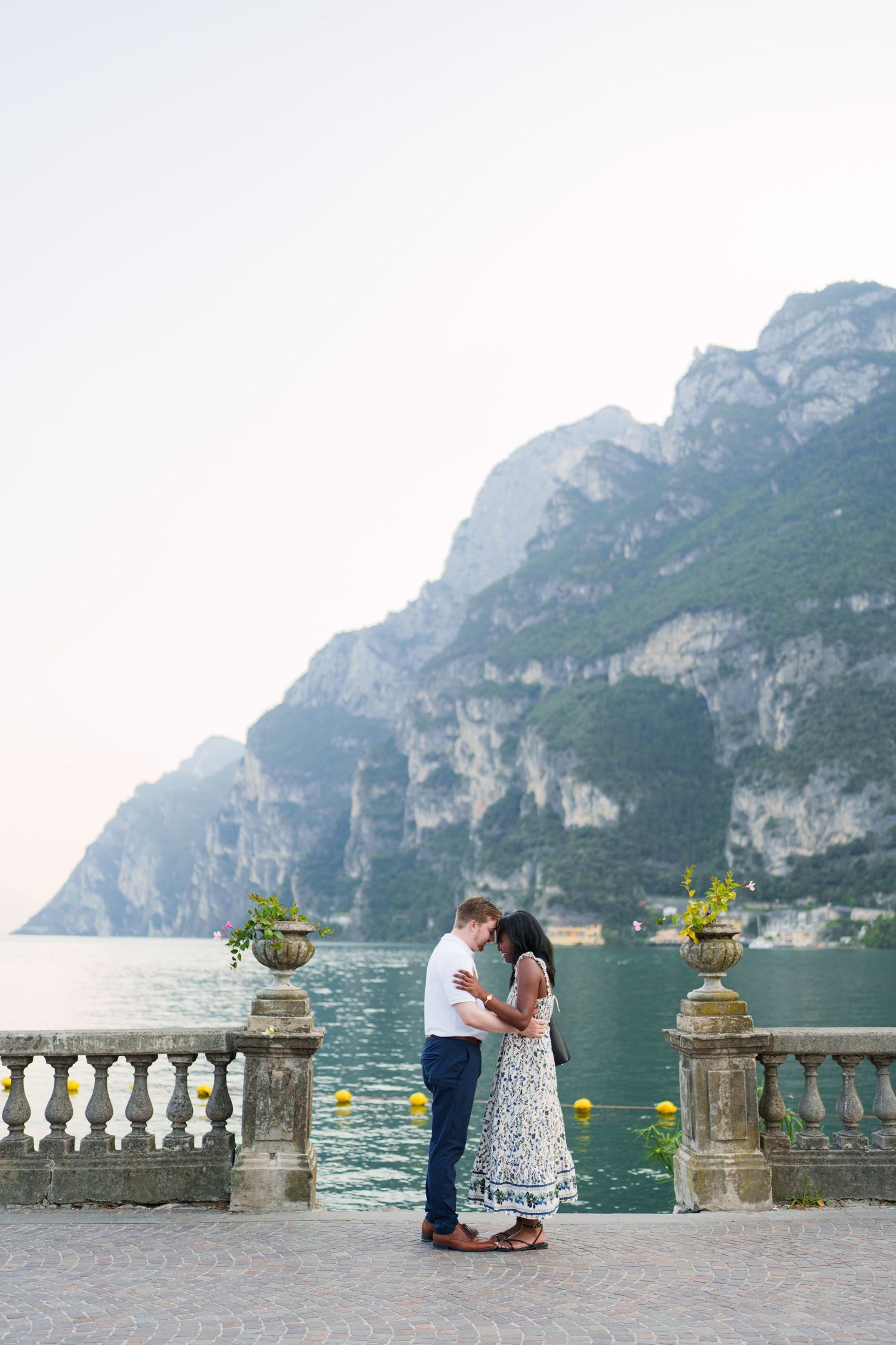 Surprise marriage proposal on one knee overlooking Lake Garda in Riva del Garda, Italy