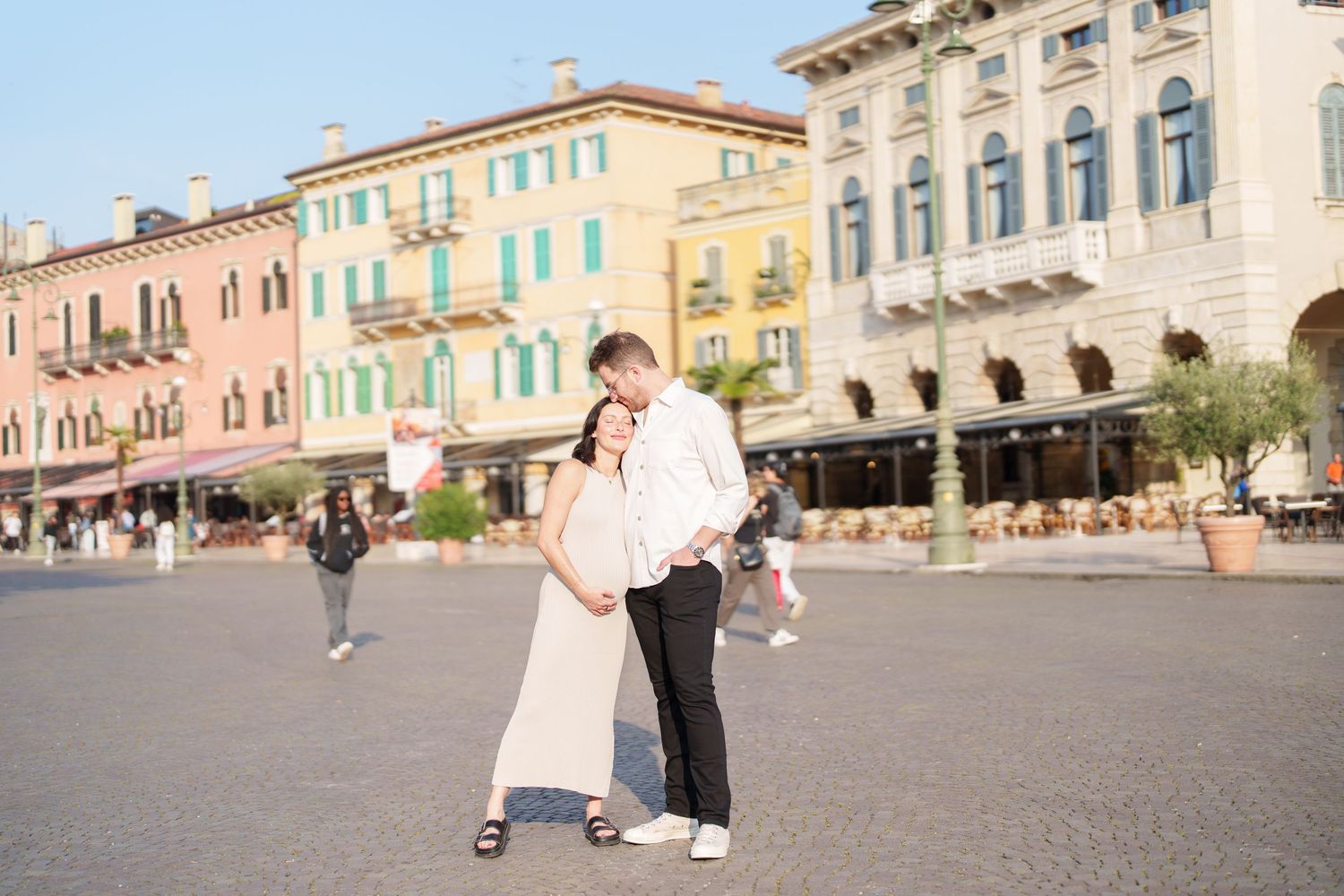 Panoramic view of colorful historic buildings along Piazza Grande in Arezzo, Italy during a sunny afternoon.