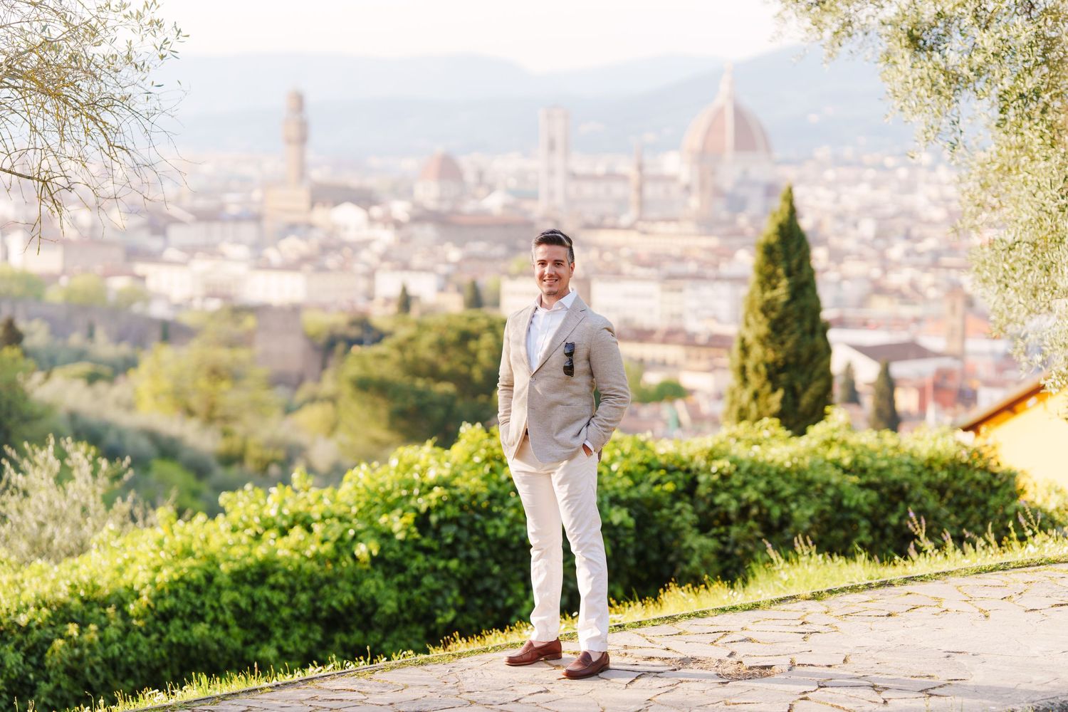A scenic overlook in Florence, Italy with the iconic Duomo cathedral and cityscape visible in the background.