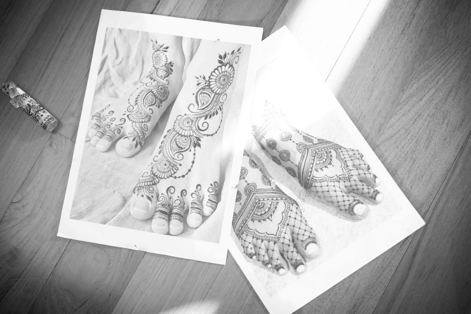Artistic henna designs and sketches displayed on white paper.