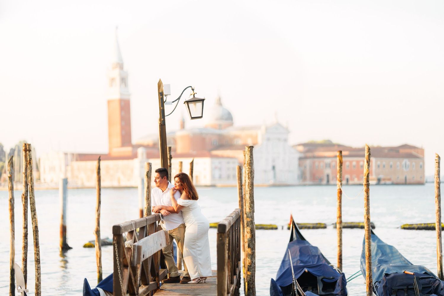 photographer venice Romantic couple enjoying a scenic view of Venice's Grand Canal with gondolas and historic buildings in the background.
