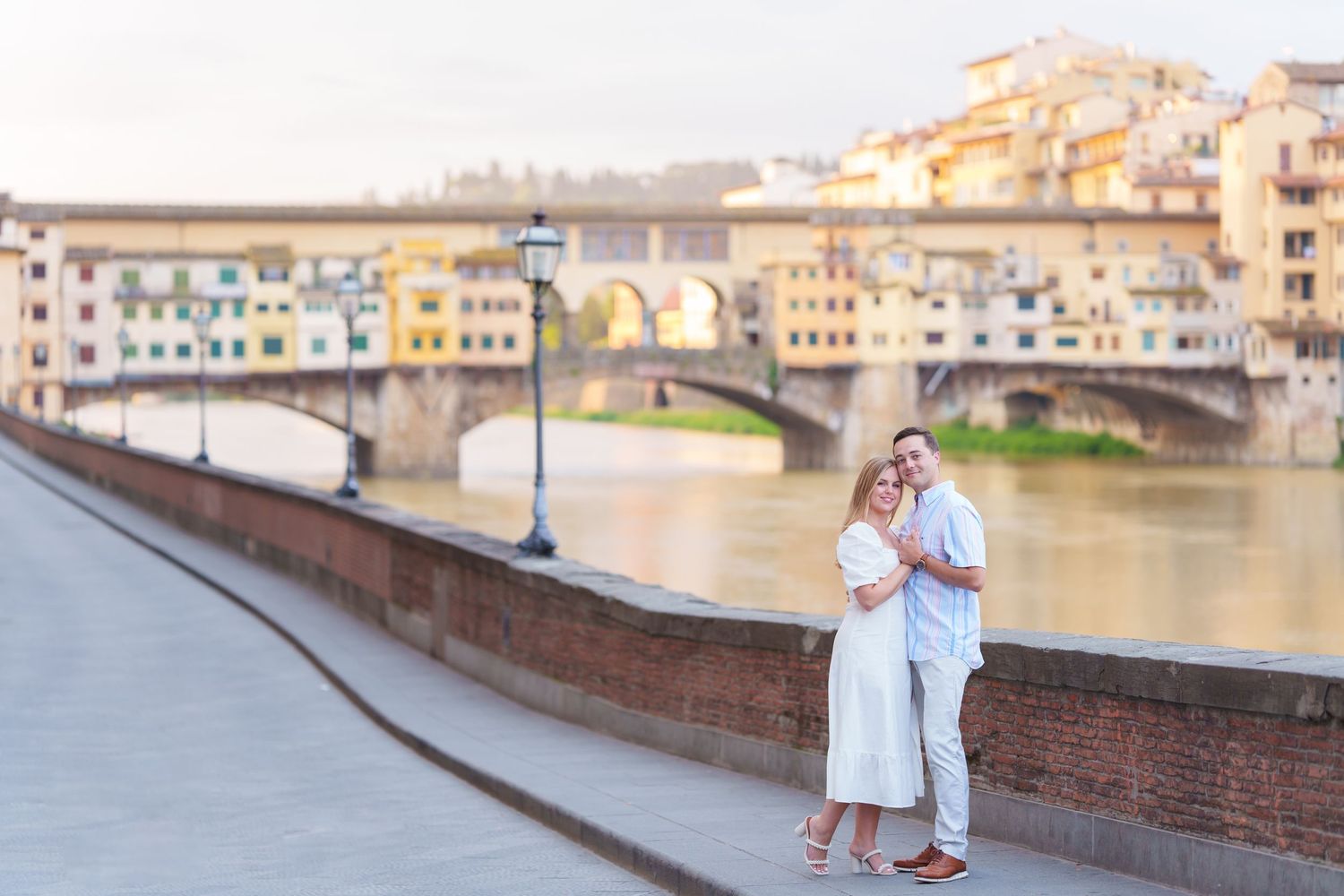 Scenic views of the Ponte Vecchio bridge and Arno River in Florence, Italy during golden hour.