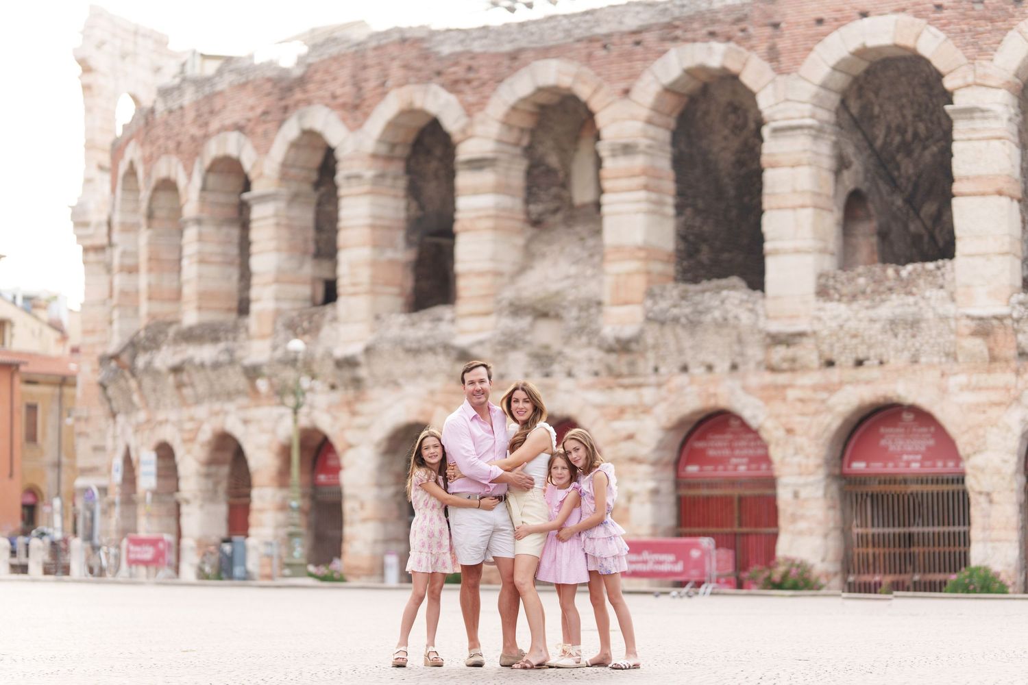Verona family photographer family walking in front of Verona Arena Italy
