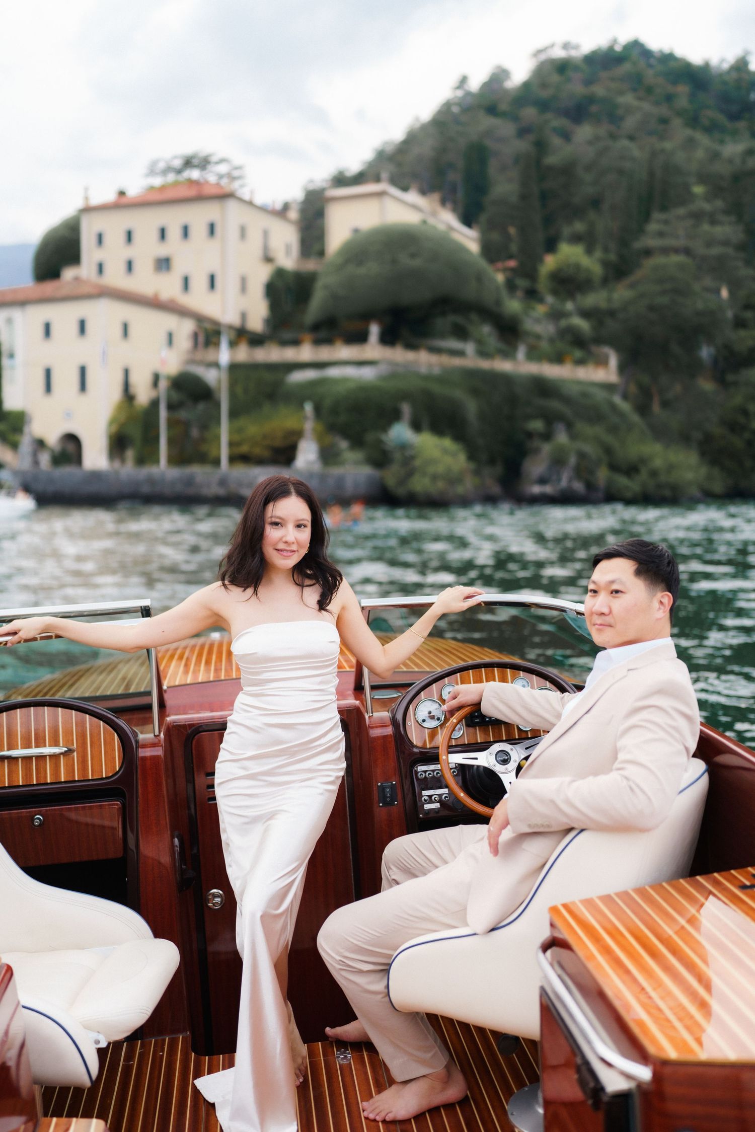 Elegant wooden boat ride on Lake Como with scenic Italian villa views and reflective waters in the background.