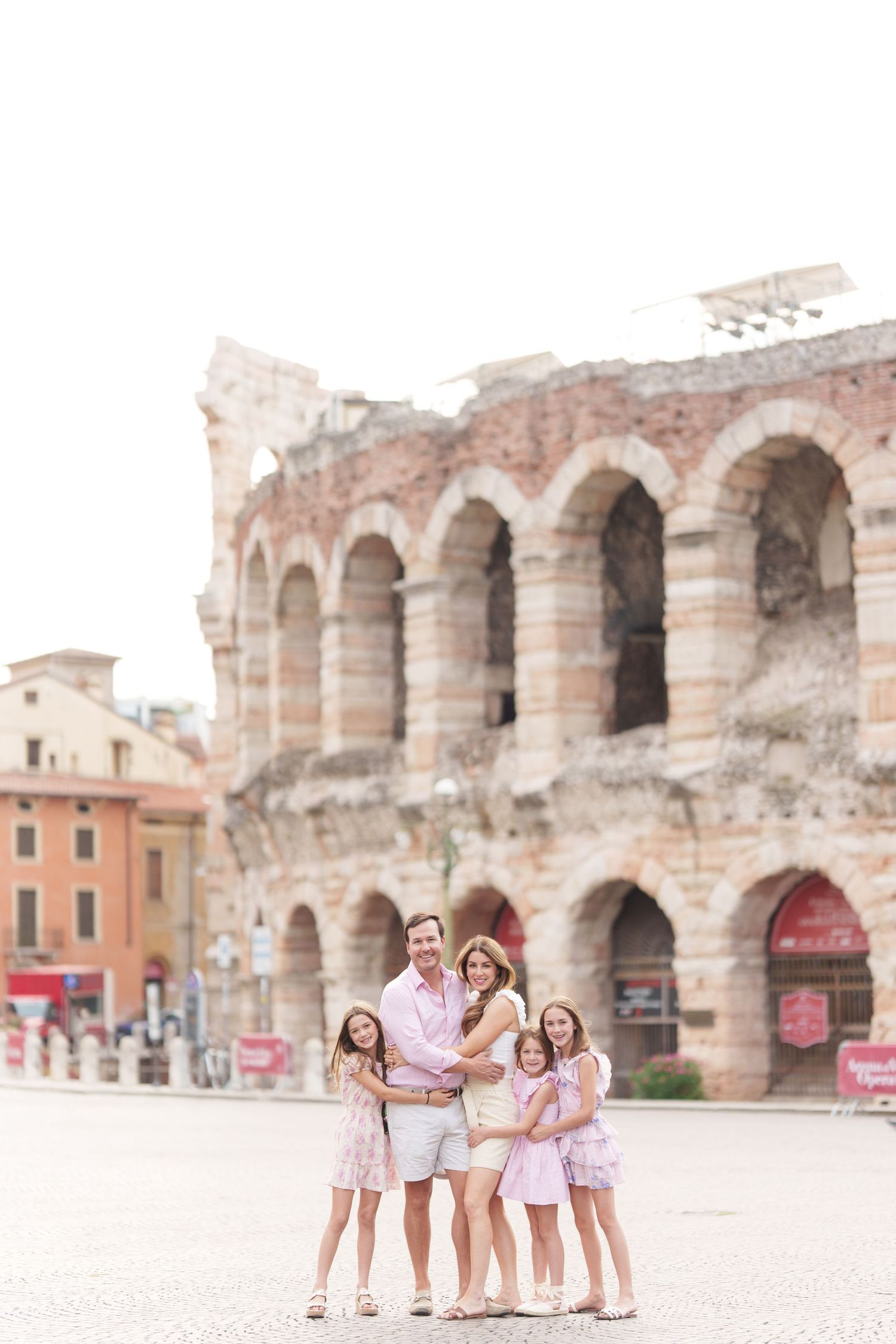 Verona family photographer family walking in front of Verona Arena Italy
