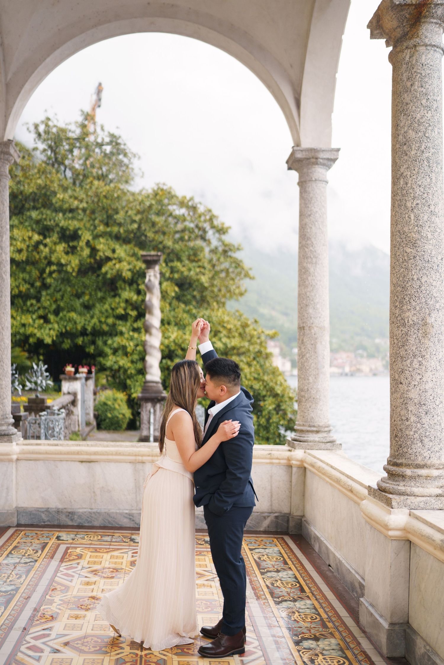 Lake Como proposal photographer capturing surprise engagement at Villa Monastero in Varenna