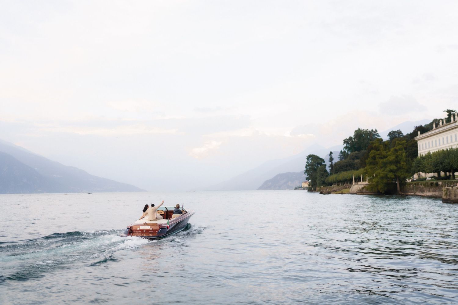 A sequence of photos showing a speedboat gradually sinking into the ocean with mountains visible in the background.