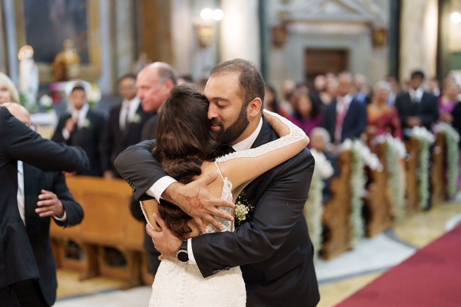 A couple shares romantic dance moments in an elegant indoor venue with warm lighting and traditional decor.