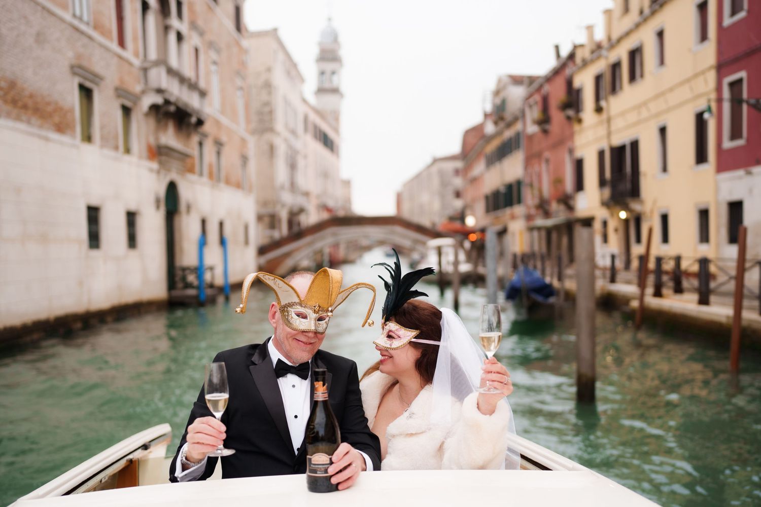 A couple shares a romantic moment while riding in a gondola through the scenic canals of Venice, Italy.