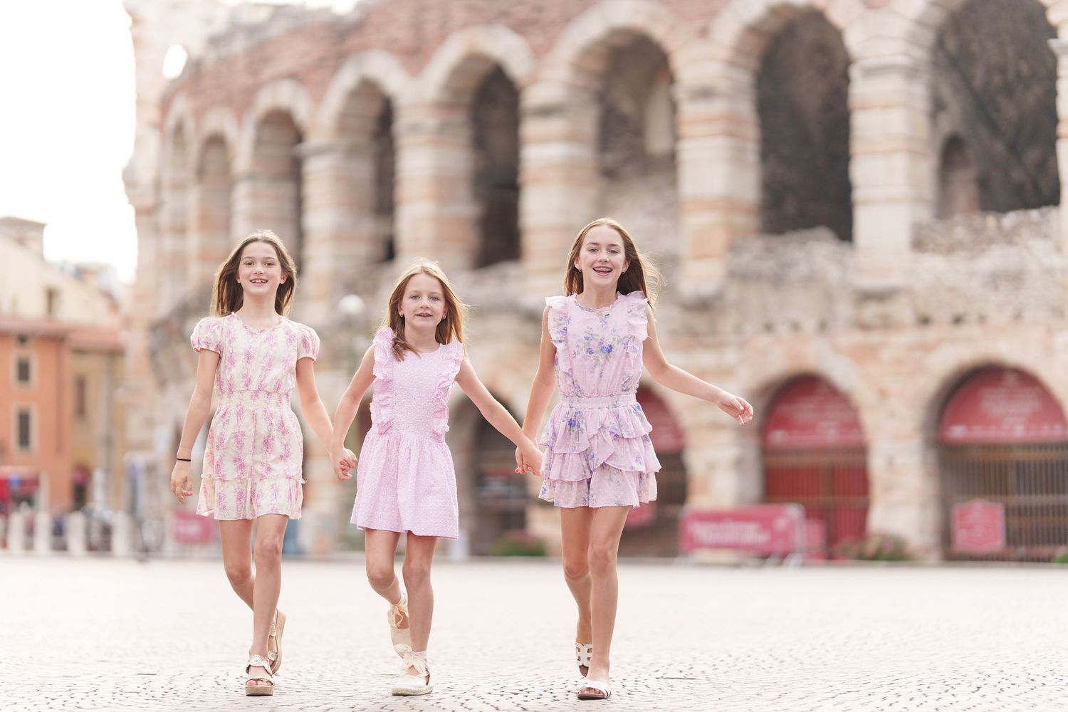 Verona family photographer family walking in front of Verona Arena Italy
