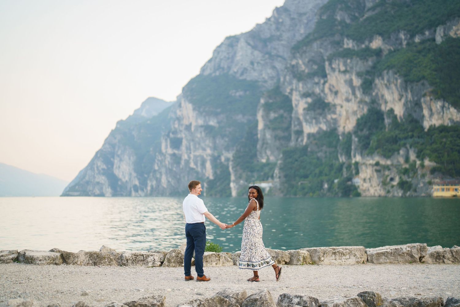 Emotional reaction during a surprise proposal beside Lake Garda in Riva del Garda