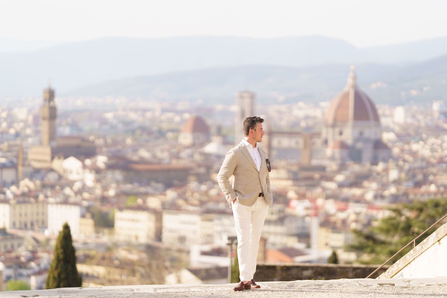 A panoramic view of Florence, Italy with the iconic Duomo cathedral and historic buildings stretching across the cityscape.