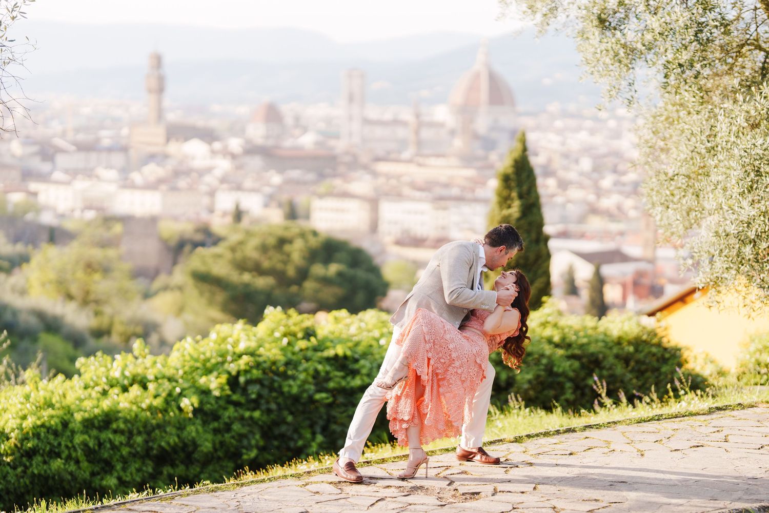 Scenic view of Florence cityscape from hilltop gardens with iconic Duomo cathedral dome visible in background.