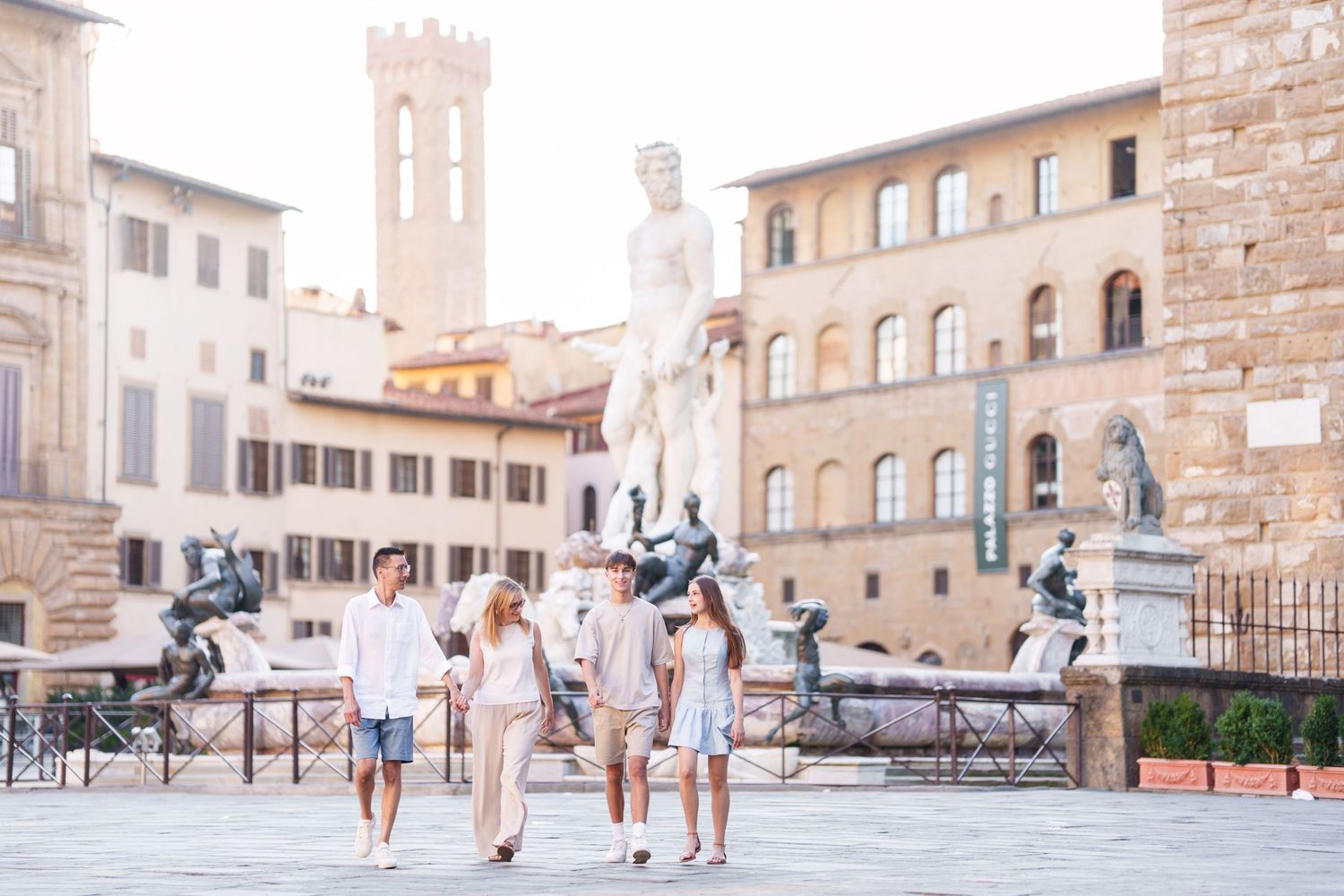 photographer Florence a summer day in Florence's Piazza della Signoria with Renaissance statues and architecture in view.
