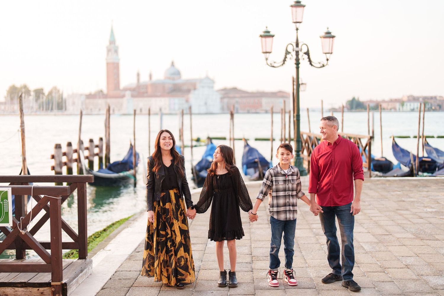 photographer venice People stroll along Venice's iconic waterfront promenade with San Giorgio Maggiore church in the background.