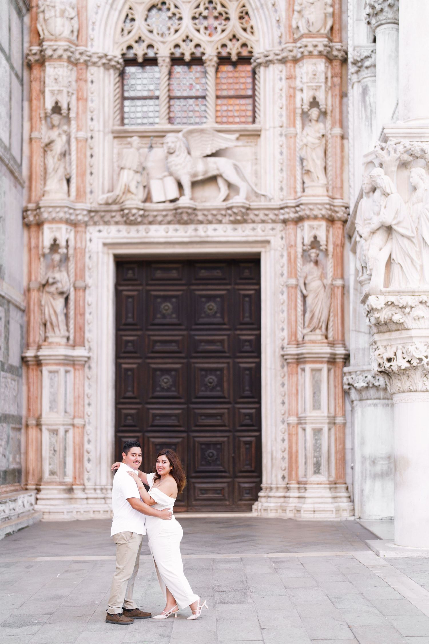 Ornate Gothic doorway of Venice's Doge's Palace with elaborate stone carvings and decorative architectural details.