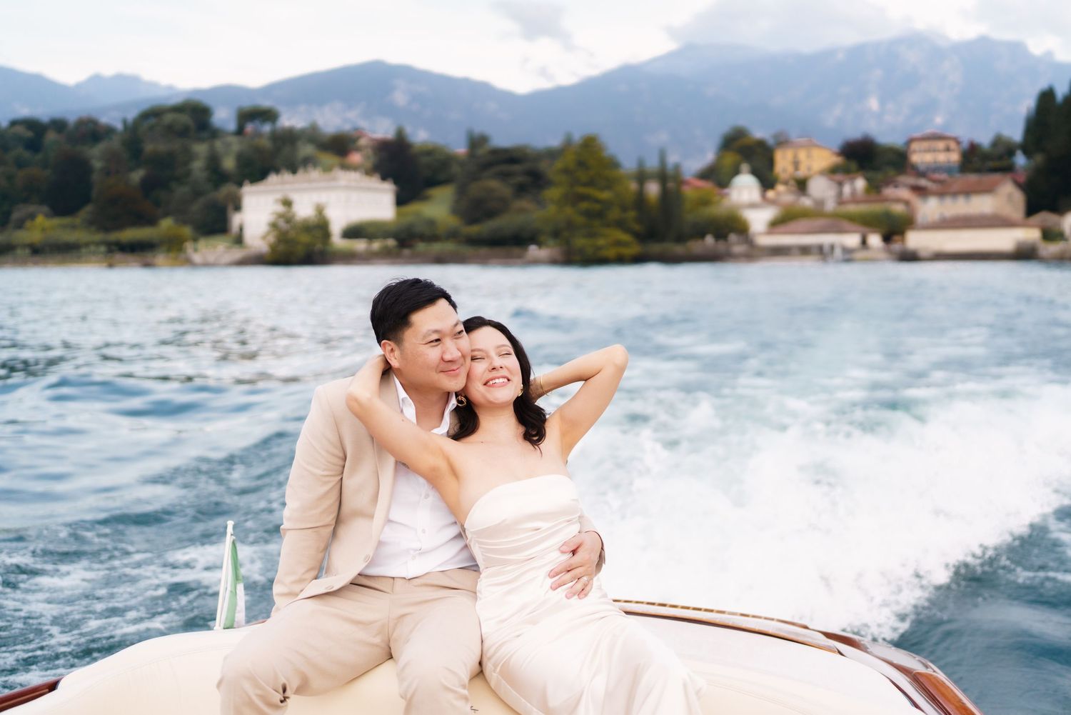 Couple relaxes on a luxury yacht during a romantic sunset cruise along the coastline.