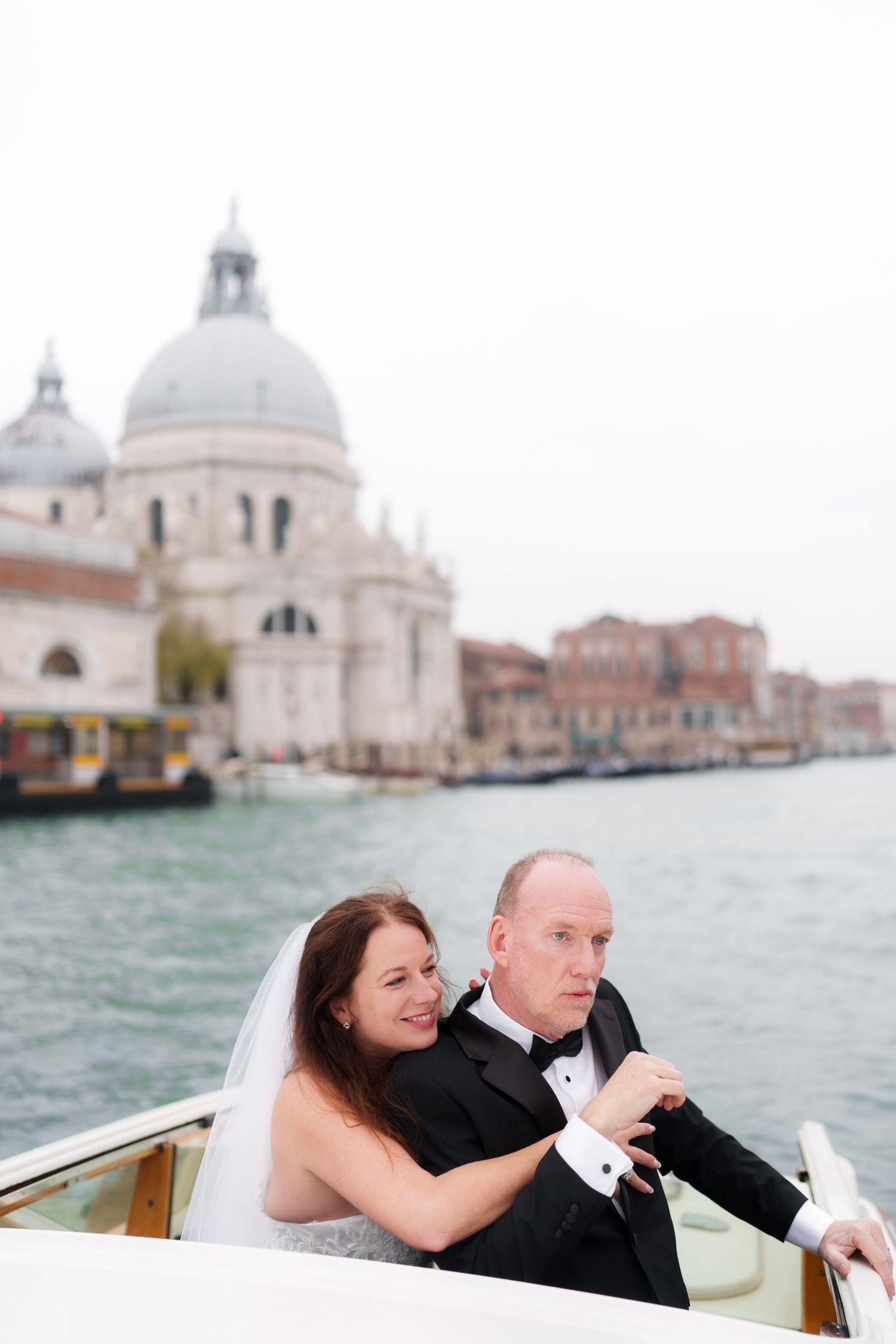 A romantic boat ride along Venice's Grand Canal with the iconic Santa Maria della Salute basilica in the background.