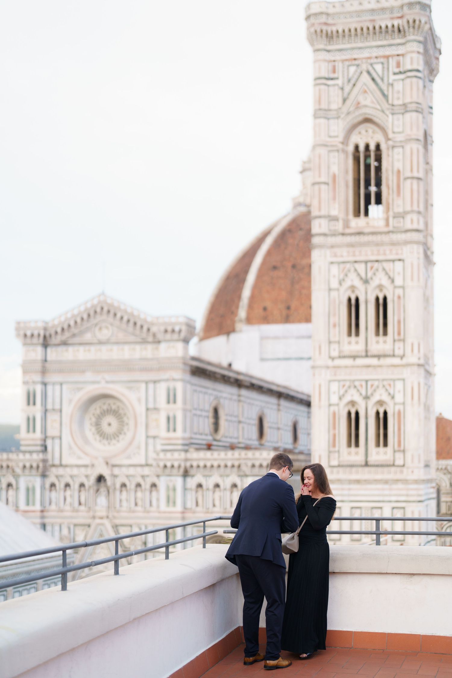 A sequence of images capturing people on a balcony with Florence's Duomo cathedral in the background.